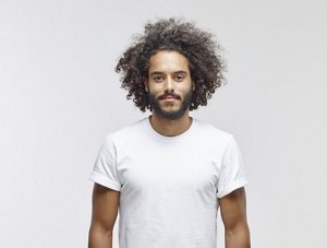 Man with natural 3C curly hair wearing a white t-shirt